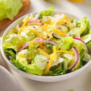 A vibrant Citrus Parmesan Salad with mixed greens, citrus segments, and shaved Parmesan cheese.