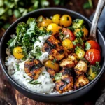 Greek Chicken Bowls topped with Tahini Feta and fresh vegetables